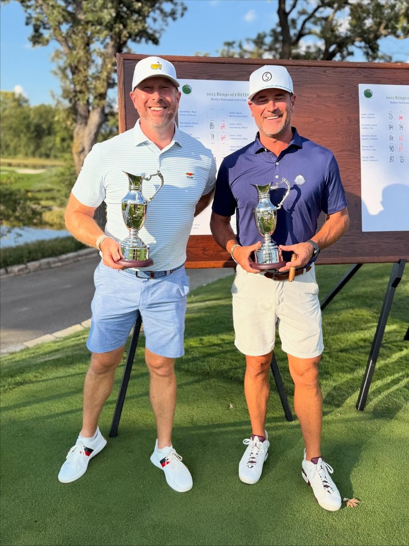 Patrick Horsman with co-winner Josh Booty holding trophies at the 2025 Kings of EBITDA invitational golf tournament, Butler National Golf Club, Illinois